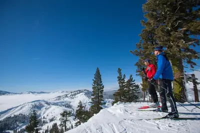 two people on skis on top of a mountain at Kokanee at Tahoe Donner - Charming 3 BR - Pool Table - Fireplace - Amenity Access! in Truckee