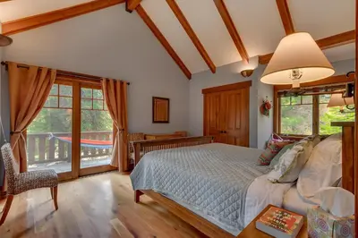 a bedroom with a bed and a balcony at Mountain Escape at North Shore - Upscale 4BR Easy Walk to Lake & Private Hot Tub! in Carnelian Bay