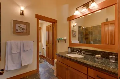 a bathroom with a sink and a mirror at Mountain Escape at North Shore - Upscale 4BR Easy Walk to Lake & Private Hot Tub! in Carnelian Bay