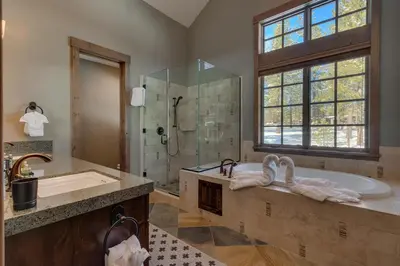a bathroom with a tub and a shower and a sink at Mountain Majesty at Grays Crossing - Luxury 4BR 4BA w Private Hot Tub in Truckee