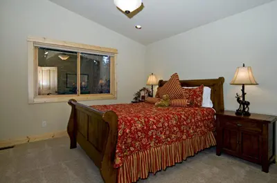 a bedroom with a large bed and a window at Olive Branch - Private Hot Tub, Media Room, Pet-Friendly, Near Northstar! in Carnelian Bay