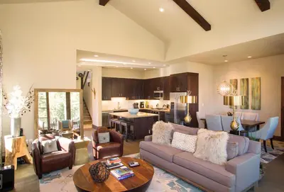 a living room with a couch and a table at Mountainside by Tahoe Getaways - Luxury Pet-Friendly Northstar Ski-in Ski-Out - Swimming Pool and Gym! in Truckee