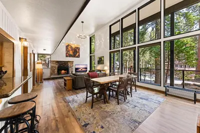a living room with a table and chairs and a fireplace at Ellis Peak Retreat - Hot Tub, Wood Fireplace, Close to Tahoe City & Dining in Tahoe City