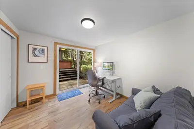 a living room with a couch and a desk with a computer at Ellis Peak Retreat - Hot Tub, Wood Fireplace, Close to Tahoe City & Dining in Tahoe City