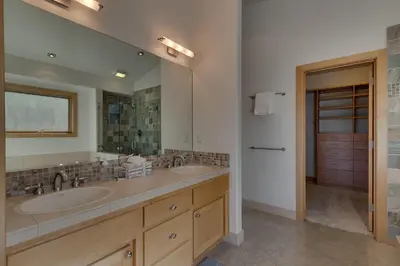 a bathroom with two sinks and a large mirror at Pinnacle Views at Tahoe Donner - 4BR, Hot Tub in Truckee