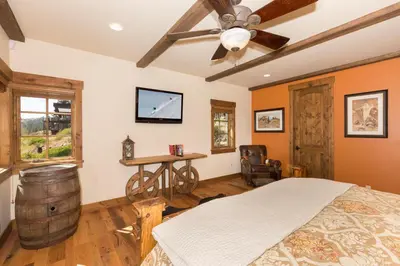 a bedroom with a bed and a wooden ceiling fan at Overlook Lake View Lodge by Tahoe Getaways- Dog Friendly, HOA, Sauna, Hot Tub, Views of Donner Lake in Truckee