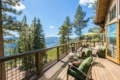 a deck with chairs and a view of the mountains at Overlook Lake View Lodge by Tahoe Getaways- Dog Friendly, HOA, Sauna, Hot Tub, Views of Donner Lake in Truckee