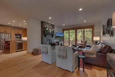 a kitchen and living room with a couch and a table at Pine Meadow at Gray's Crossing - 4BR w Two Master Suites in Truckee