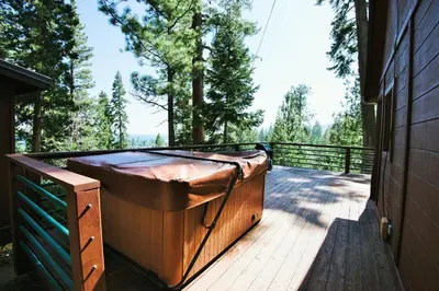 a wooden deck with a hot tub on the side of a house at Pioneer Lake View- 4BR Easy Walk to Town Private Hot Tub - Sleeps 11 in Tahoe City