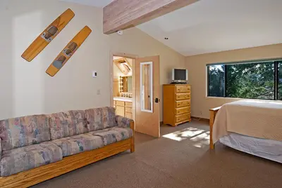 a living room with a couch and a bed at Pioneer Lake View- 4BR Easy Walk to Town Private Hot Tub - Sleeps 11 in Tahoe City