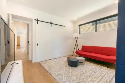 a living room with a red couch and a rug at Powder Run - Newly Built Palisades 3 Bedroom Townhome - Minutes to Village in Olympic Valley