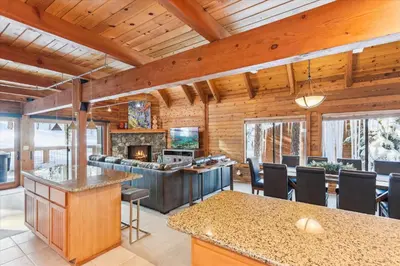 an open kitchen and living room with a fireplace at Ponderosa Pines - Custom 3 BR - Pet Friendly Private Hot Tub - Ski Shuttle in Truckee