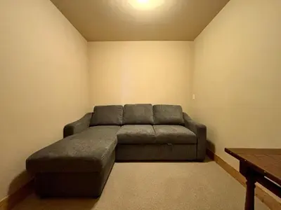 a living room with a couch in the corner at Water's Edge Lakefront- Buoy, Private Pier in Tahoe City