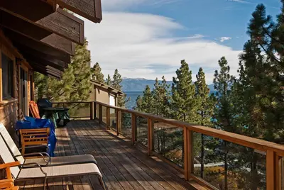 a balcony with chairs and a view of the mountains at Water's Edge Lakefront- Buoy, Private Pier in Tahoe City