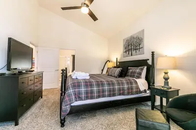 a bedroom with a bed and a flat screen tv at Wolf Den - Bright Open Concept 3 Bedroom- Hot Tub, Pet-Friendly, Minutes from Skiing! in Tahoma