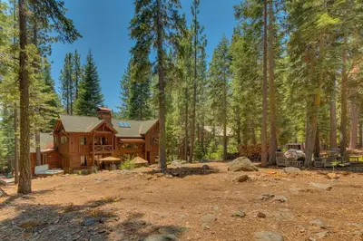 a log home in the woods with trees at New Listing! West Shore Bliss - 4BR, Private Hot Tub in Tahoe City