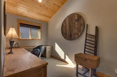 a room with a desk and a clock on the wall at Woodcrest at Tahoe Donner 3BR with Pool Table - 3000 sq ft in Truckee