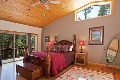 a bedroom with a bed with a wooden ceiling at Woodside Lodge on West Shore with Private Hot Tub, Pool Table & Game Room in Tahoma