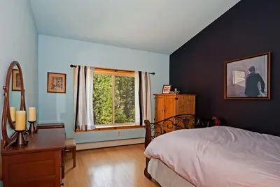 a bedroom with a bed and a desk and a window at Woodside Lodge on West Shore with Private Hot Tub, Pool Table & Game Room in Tahoma
