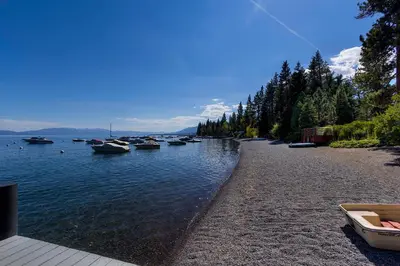 a group of boats are docked on a river at New Listing! Woodland Heights at Tahoe Park- Pet Friendly - Private Beach in Tahoe City