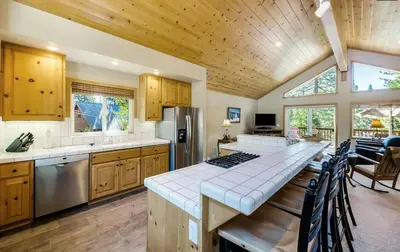 a kitchen with a long table with a counter top at New Listing! Woodland Heights at Tahoe Park- Pet Friendly - Private Beach in Tahoe City