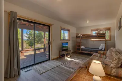 a living room with a couch and a bunk bed at Stockholm - Beautiful Views in Tahoe Donner - Private Hot Tub - Pet Friendly in Truckee