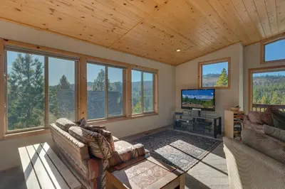 a living room with a couch and a tv at Stockholm - Beautiful Views in Tahoe Donner - Private Hot Tub - Pet Friendly in Truckee