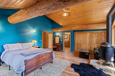 a bedroom with a bed and a wooden ceiling at Tahoe Wanderer - 3 BR Luxury Log Cabin with Additional Loft, Private Hot Tub in Tahoe Vista