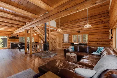 a living room with a couch and a fireplace at Tahoe Wanderer - 3 BR Luxury Log Cabin with Additional Loft, Private Hot Tub in Tahoe Vista
