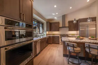 a kitchen with wooden cabinets and stainless steel appliances at Lavish 4 BR in Gray's Crossing in Truckee