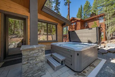 a hot tub on a patio outside of a house at Lavish 4 BR in Gray's Crossing in Truckee