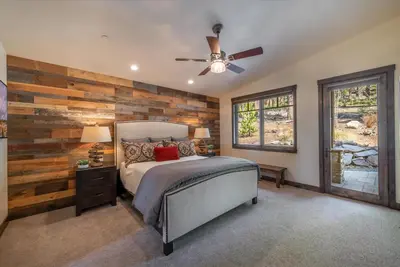 a bedroom with a wooden accent wall and a bed at Lavish 4 BR in Gray's Crossing in Truckee