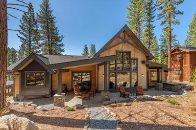 a log home with a fireplace in a yard at Lavish 4 BR in Gray's Crossing in Truckee