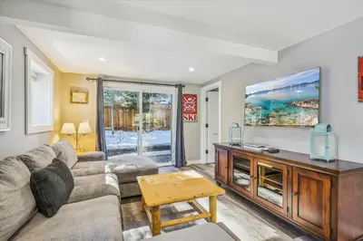 a living room with a couch and a table at Granlibakken Getaway by Tahoe Getaways - West Shore Retreat-Central Location-Hot Tub-Dog Considered-Near Skiing in Tahoe City