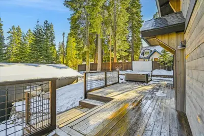 a deck with a grill and snow on a house at Granlibakken Getaway by Tahoe Getaways - West Shore Retreat-Central Location-Hot Tub-Dog Considered-Near Skiing in Tahoe City