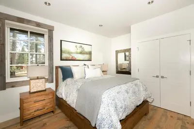 a bedroom with a bed and a window at First Light Farmhouse- Hot Tub- Gourmet Kitchen- Premier Neighborhood in Truckee