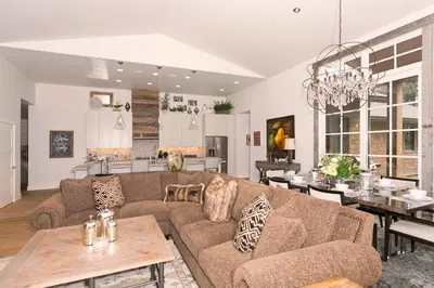 a living room with a couch and a table at First Light Farmhouse- Hot Tub- Gourmet Kitchen- Premier Neighborhood in Truckee