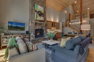 a living room with two couches and a fireplace at Truckee Treasure at Grays Crossing by Tahoe Getaways - Relaxing Home w Private Hot Tub, Dogs Welcome! in Truckee