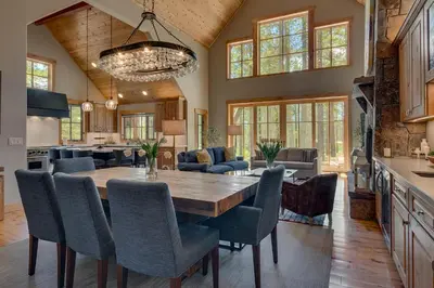 a kitchen and dining room with a wooden table and chairs at Truckee Treasure at Grays Crossing by Tahoe Getaways - Relaxing Home w Private Hot Tub, Dogs Welcome! in Truckee