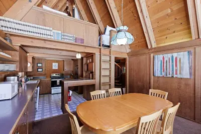 a kitchen and dining room with a wooden table and chairs at Snowy Paws - Pet Friendly - Alpine Meadows - Amazing views, close to slopes in Olympic Valley