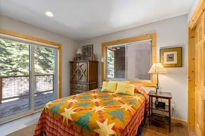 a bedroom with a bed and a window at Trailside - Alpine Meadows 6 Bedroom with Private Hot tub in Alpine Meadows