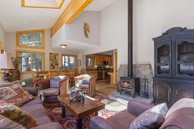 a living room with a couch and a fireplace at Trailside - Alpine Meadows 6 Bedroom with Private Hot tub in Alpine Meadows