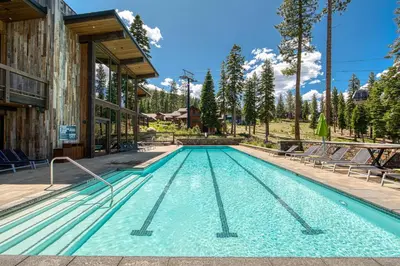 a swimming pool in the middle of a building at Stellar Ski-in Ski-out Townhouse 8 - Luxury 3 BR w Private Hot Tub and Gym and Pool Access in Truckee