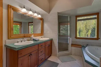 a bathroom with two sinks and a shower at Swiss Chalet-Palisades, 6 BR, Hot Tub, Pets Ok, Ski Shuttle! in Olympic Valley
