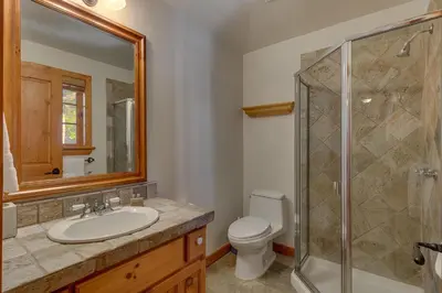 a bathroom with a toilet and a sink and a shower at Swiss Chalet-Palisades, 6 BR, Hot Tub, Pets Ok, Ski Shuttle! in Olympic Valley