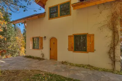 a house with a front door and windows at Swiss Chalet-Palisades, 6 BR, Hot Tub, Pets Ok, Ski Shuttle! in Olympic Valley