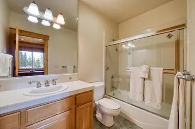 a bathroom with a sink toilet and a shower at Fawn View by Tahoe Getaways - Spacious 5 BR w Pool Table-Short Drive to Northstar in Tahoe Vista