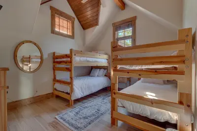 a bedroom with two bunk beds and a mirror at Highland Estate at Old Greenwood - Large, Luxury, Private Hot Tub & Amenity Access in Truckee