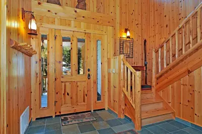 a wooden hallway with a staircase in a house at Sierra Crest at Palisades Tahoe - Secluded Luxury 5BR 5 BA w Wood Fireplace in Olympic Valley
