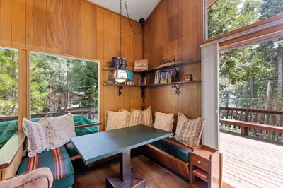 a room with a table and chairs in a house at Starry Skies on the West Shore, Private Beach, Fireplace, Pet Friendly, Close to Ski Resorts in Tahoe City
